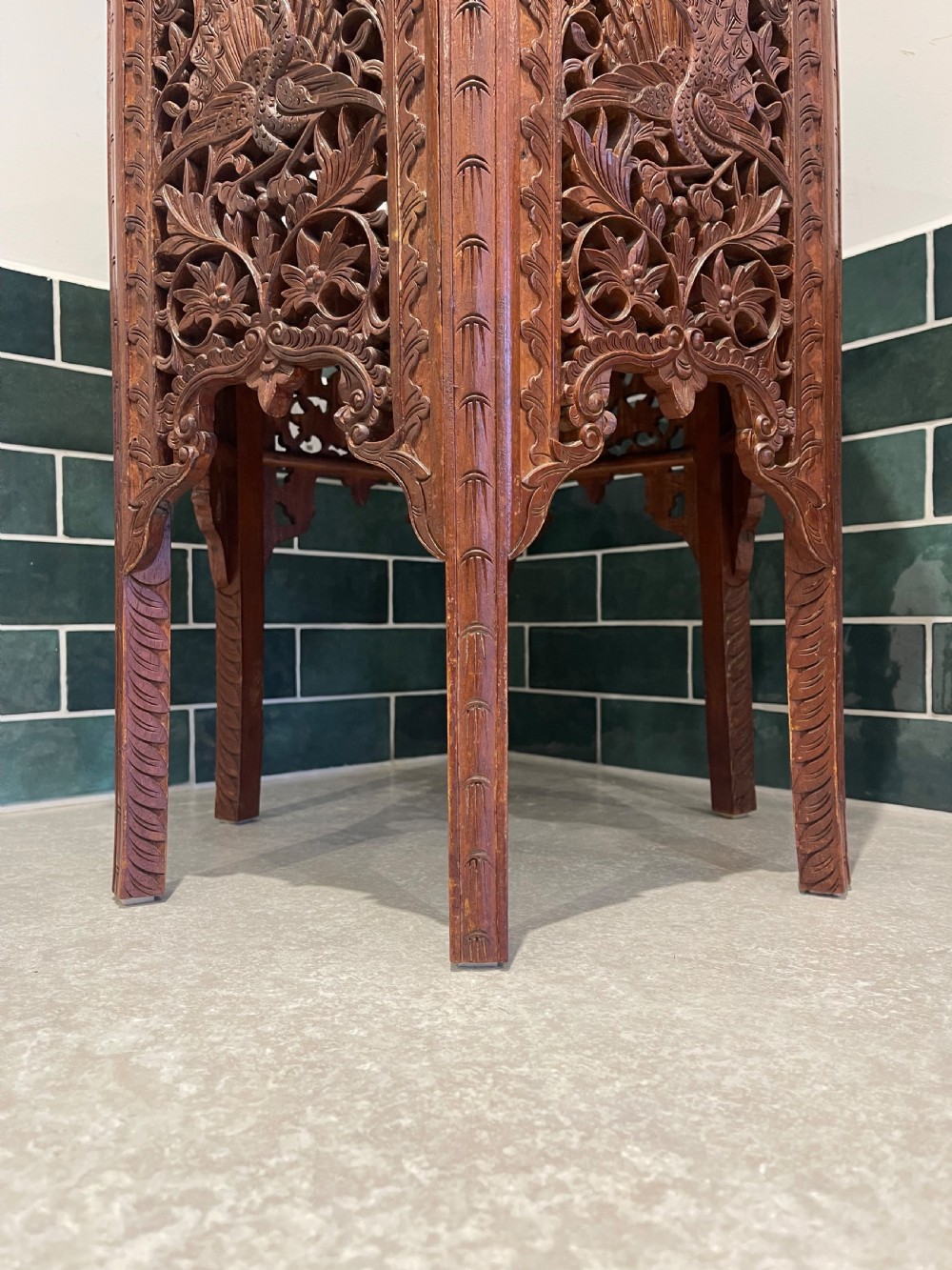 A dark hardwood hexagonal side table featuring intricate hand-carved floral fretwork and pierced side panels with peacock motifs. View IV
