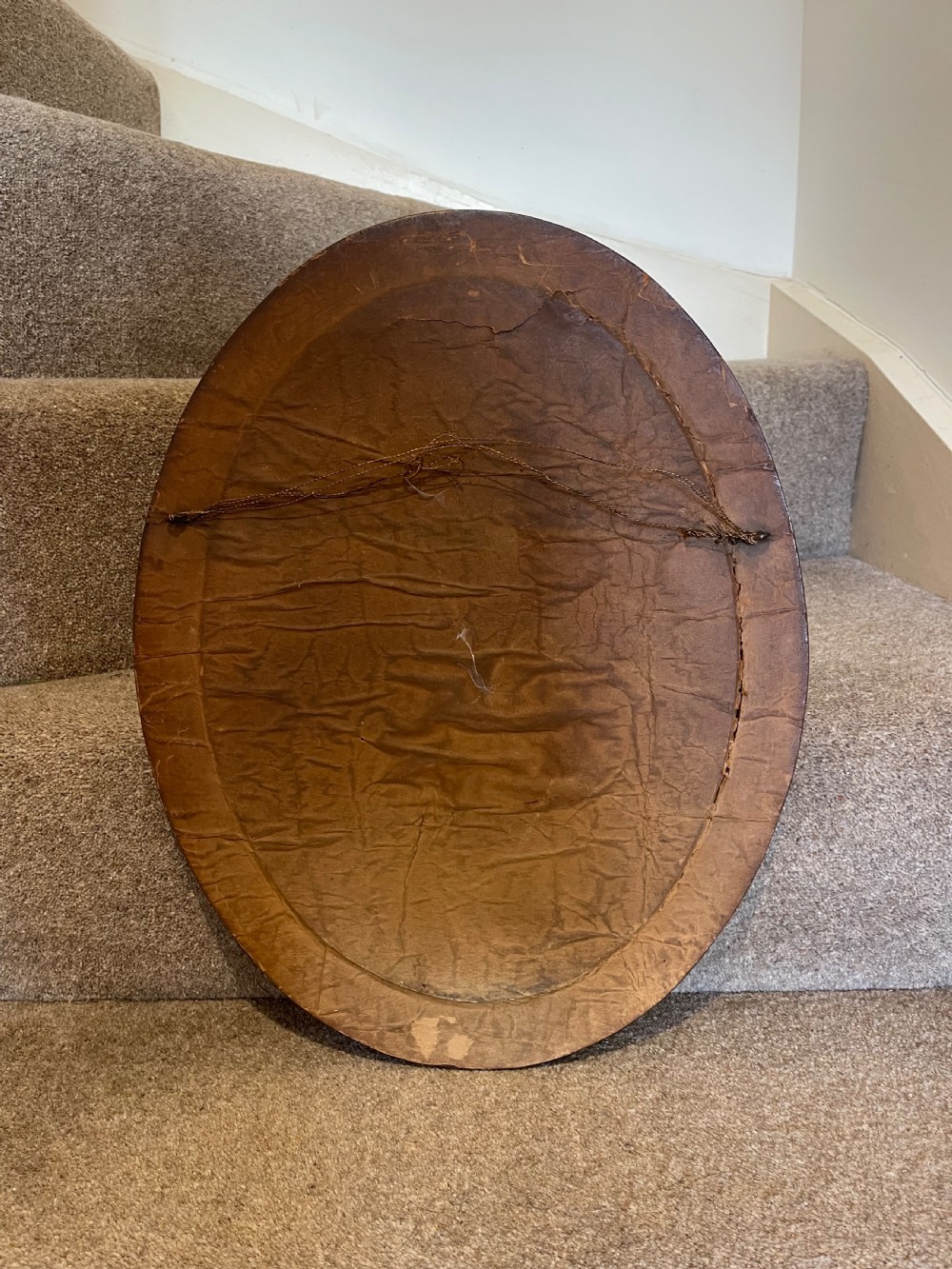 An oval wall mirror featuring a dark brown wooden frame decorated with detailed geometric chip-carved rosette patterns. View II