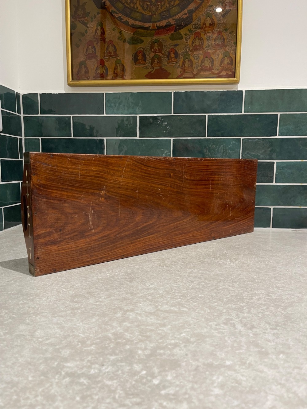 A rectangular warm brown wooden tray featuring intricate white bone inlay in a central floral rosette motif and surrounding foliate borders with cut-out handles. View III