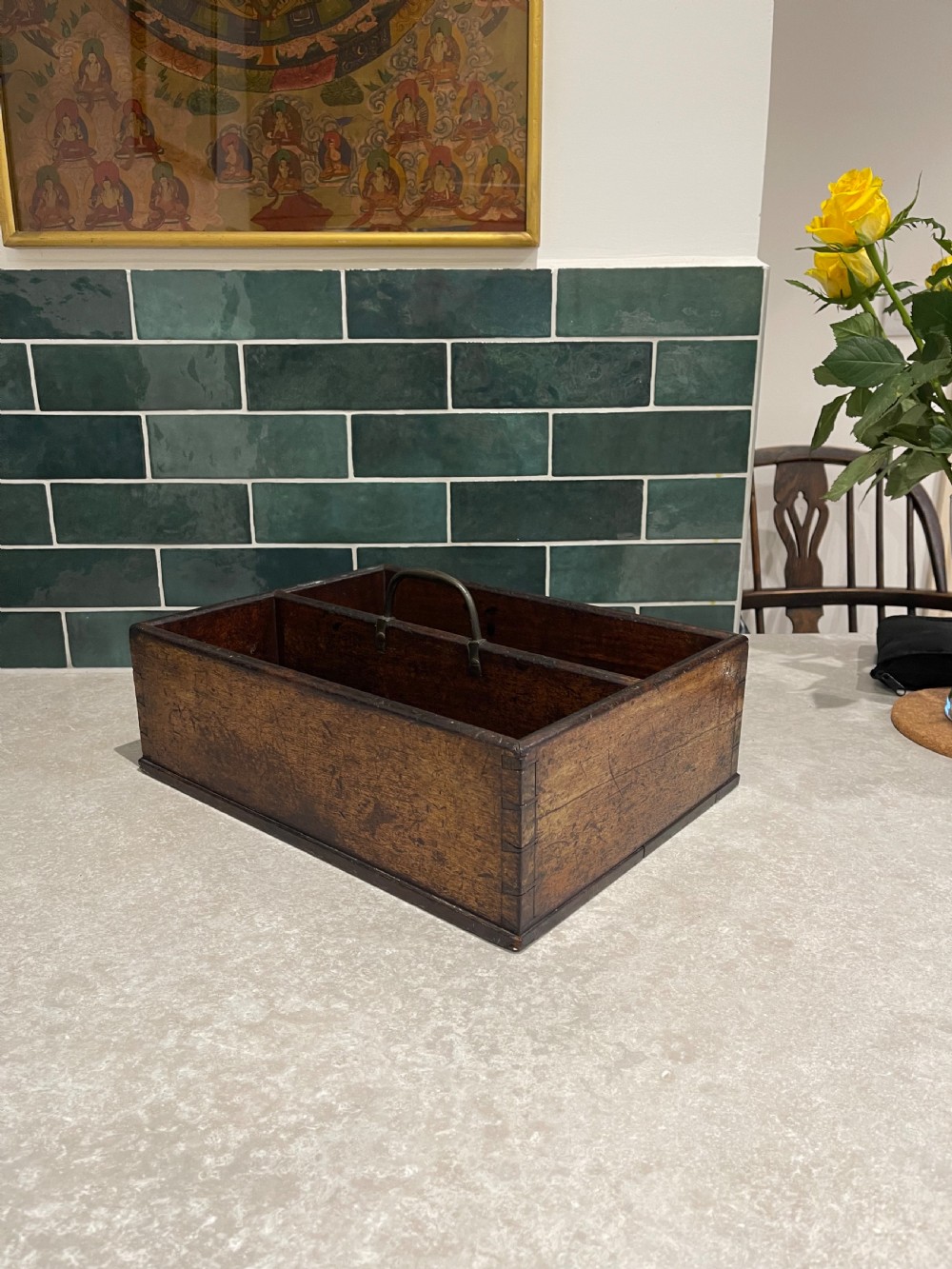A rectangular dark mahogany wood cutlery box featuring two open compartments, visible corner dovetail joints, and a central metal carrying handle.