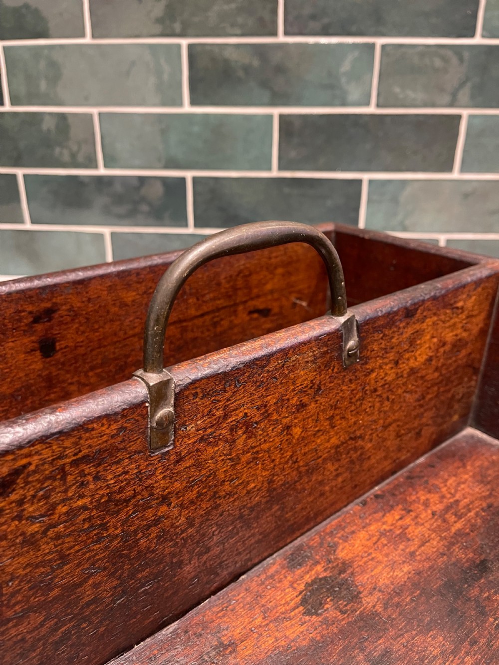 A rectangular dark mahogany wood cutlery box featuring two open compartments, visible corner dovetail joints, and a central metal carrying handle. View III