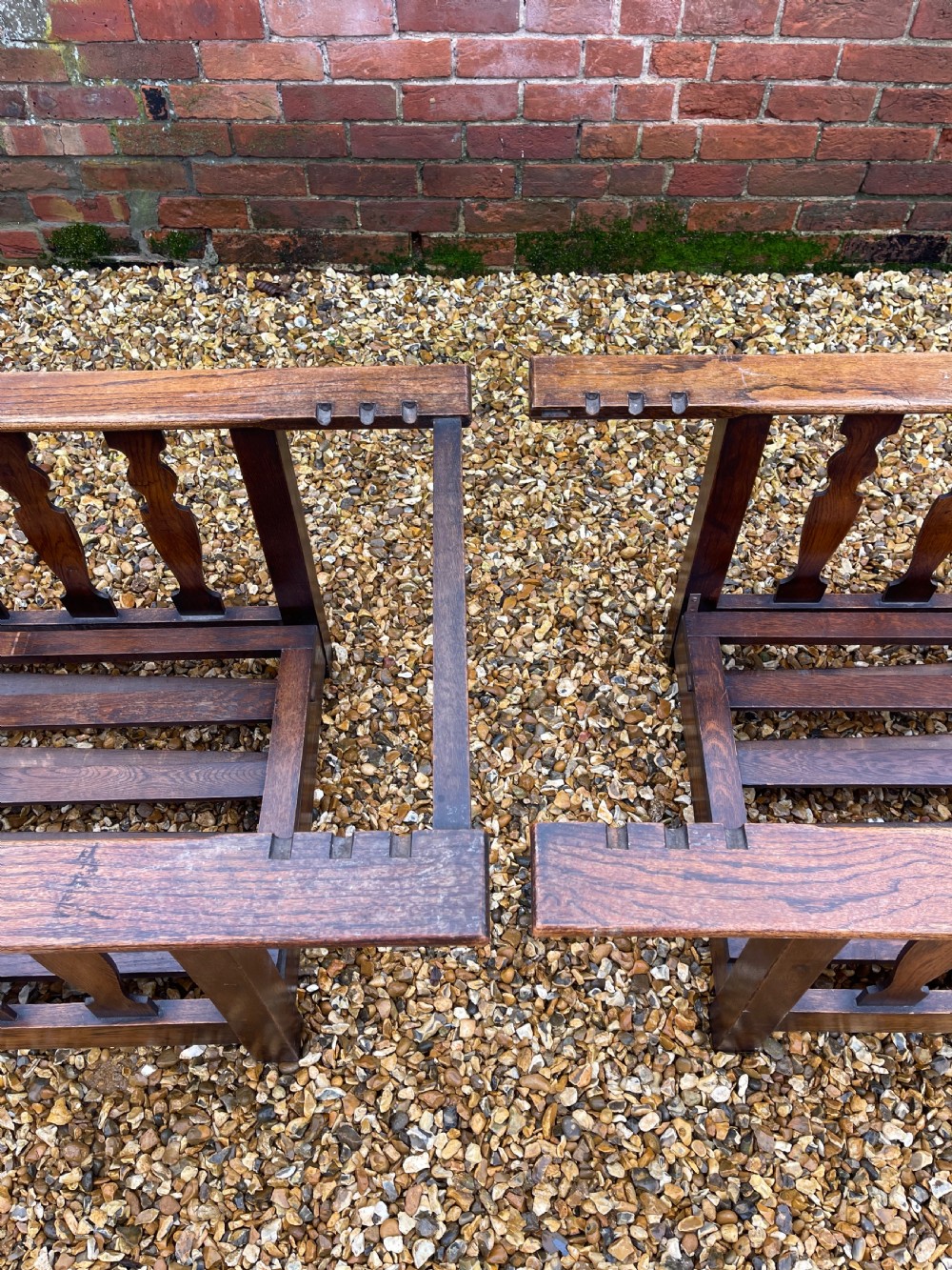 A pair of oak reclining armchairs with floral upholstered cushions, barley twist front arm supports, and slatted side panels. View III