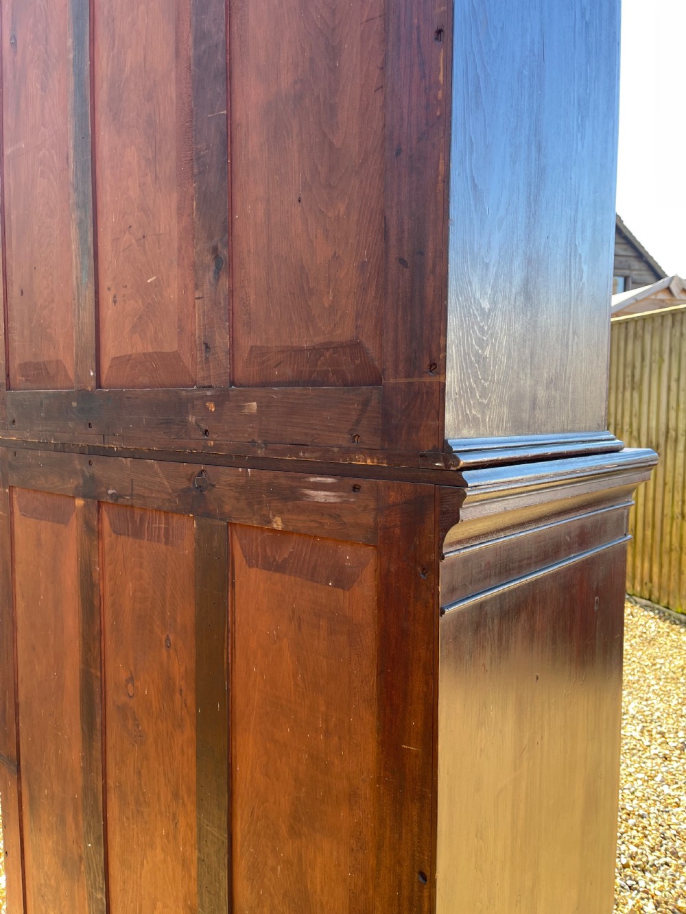 A tall dark mahogany two-door glazed bookcase featuring a concave front facade and gothic pointed arch glazing bars. View III