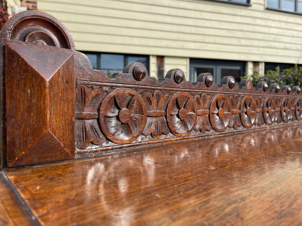A Victorian oak hall table featuring a carved rosette gallery back, decorative apron, and front bobbin-turned legs. View III