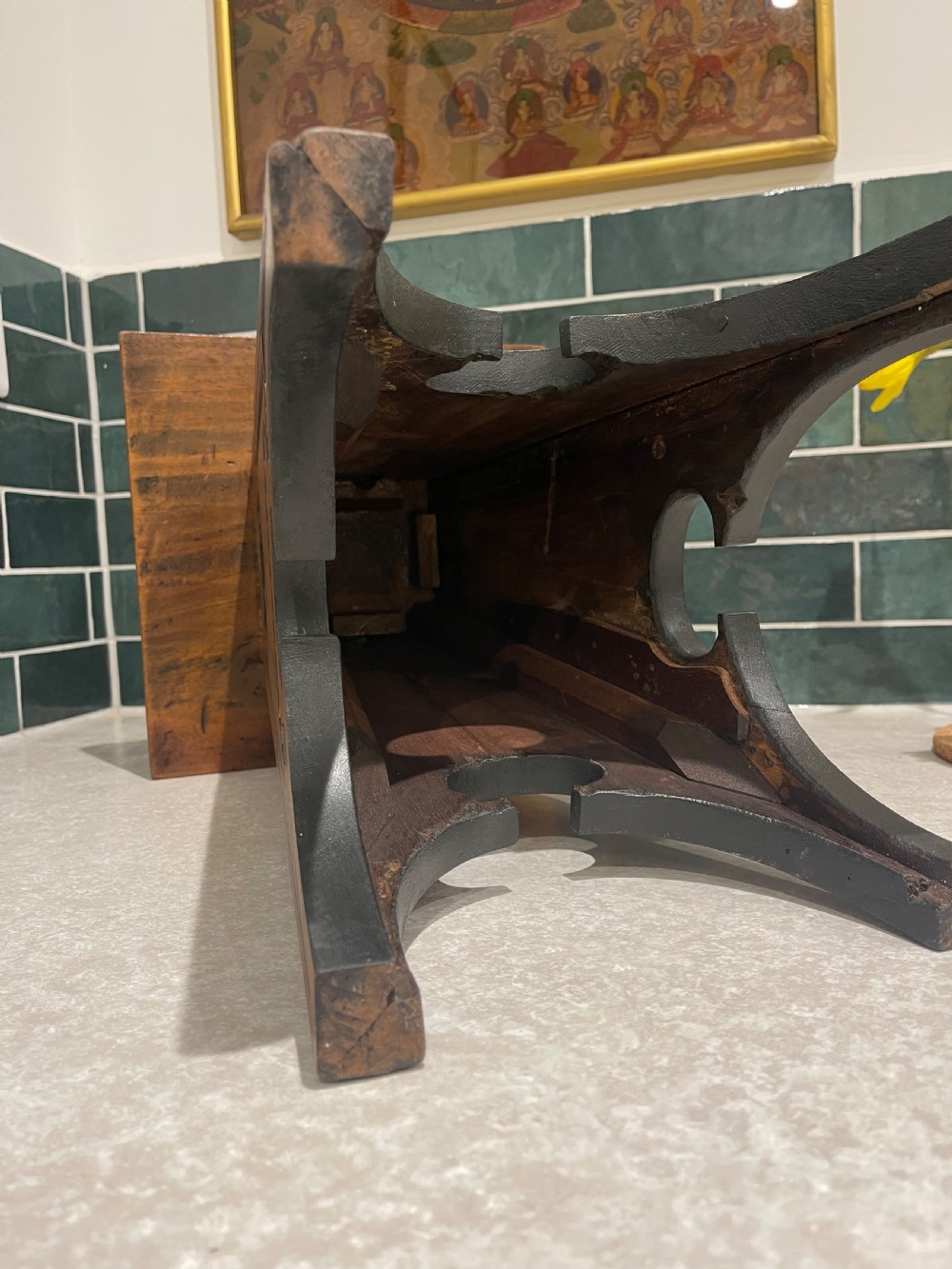 A carved walnut occasional table featuring ebonised geometric chip carving, shell motifs, and four tapered flared legs. View III