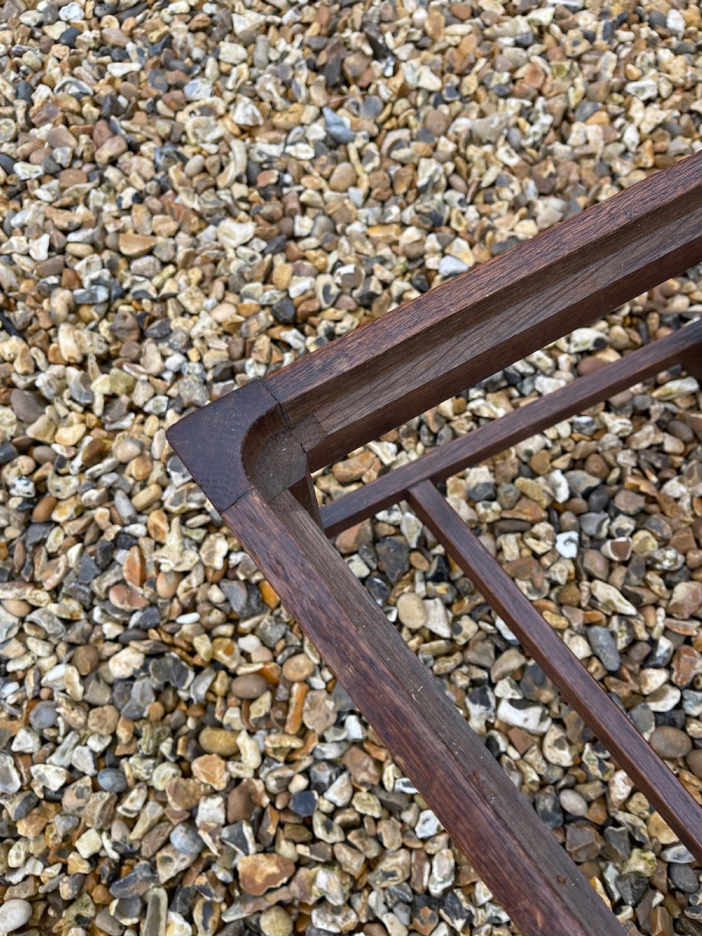 A pair of dark oak antique side chairs with intricately carved openwork back splats and tan upholstered seats. View IV