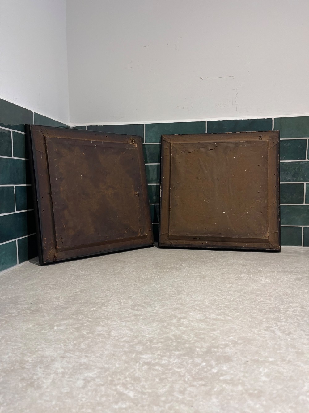 A pair of square dark wood framed mirrors featuring a border of convex glass studs surrounding the central mirrored glass panel. View II