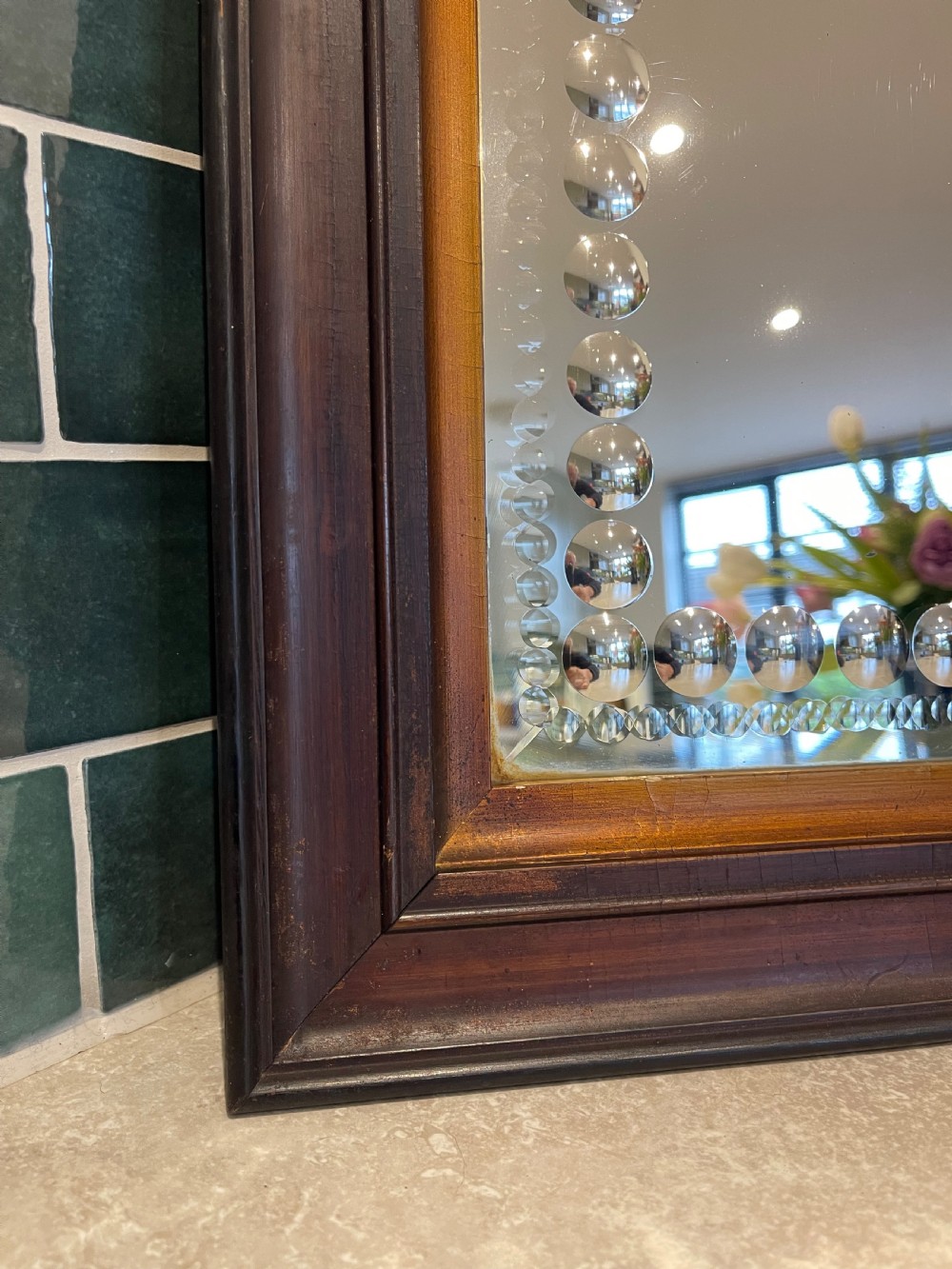A pair of square dark wood framed mirrors featuring a border of convex glass studs surrounding the central mirrored glass panel. View III