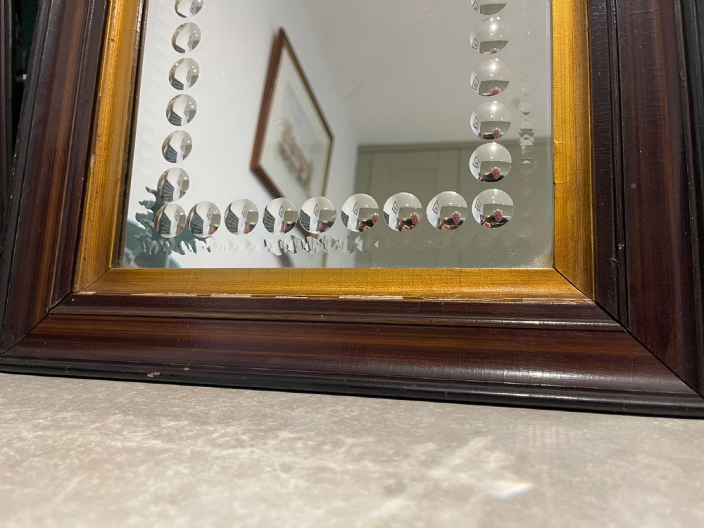 A pair of square dark wood framed mirrors featuring a border of convex glass studs surrounding the central mirrored glass panel. View IV