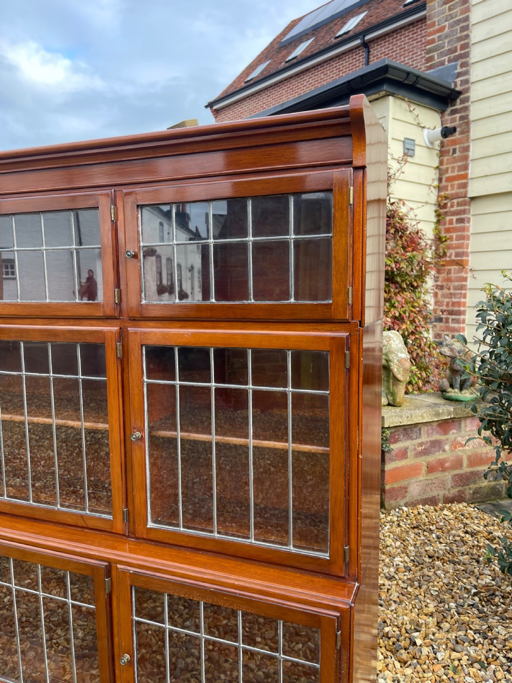 An oak modular stacking bookcase featuring nine leaded glass cabinet doors arranged in three rows. View II