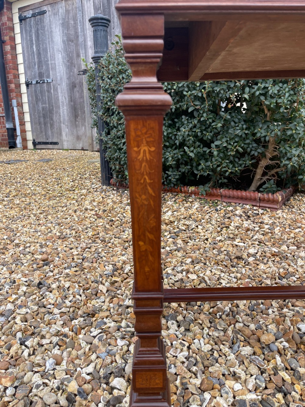 A Victorian inlaid mahogany writing table featuring a single drawer with brass drop handles, floral marquetry, square tapered legs, and an H-stretcher base. View III
