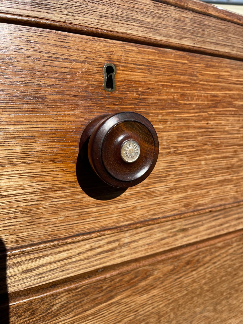 A nineteenth-century Welsh oak press cupboard featuring an upper double-door section with arched fielded panels over a base with four drawers. View VIII