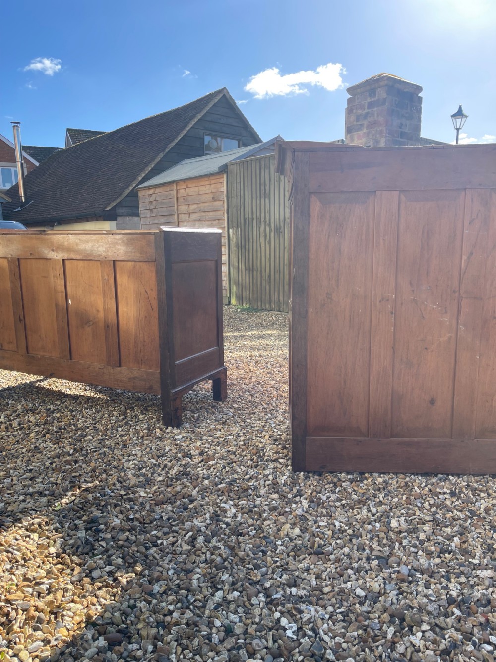 A nineteenth-century Welsh oak press cupboard featuring an upper double-door section with arched fielded panels over a base with four drawers. View IX