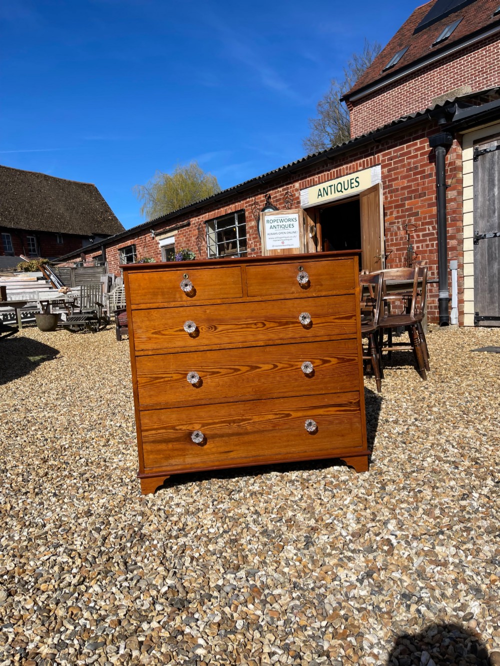 A Victorian pitch pine chest of drawers featuring two short drawers above three long graduated drawers with cut-glass handles.