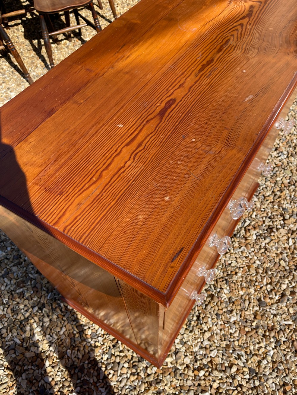 A Victorian pitch pine chest of drawers featuring two short drawers above three long graduated drawers with cut-glass handles. View II