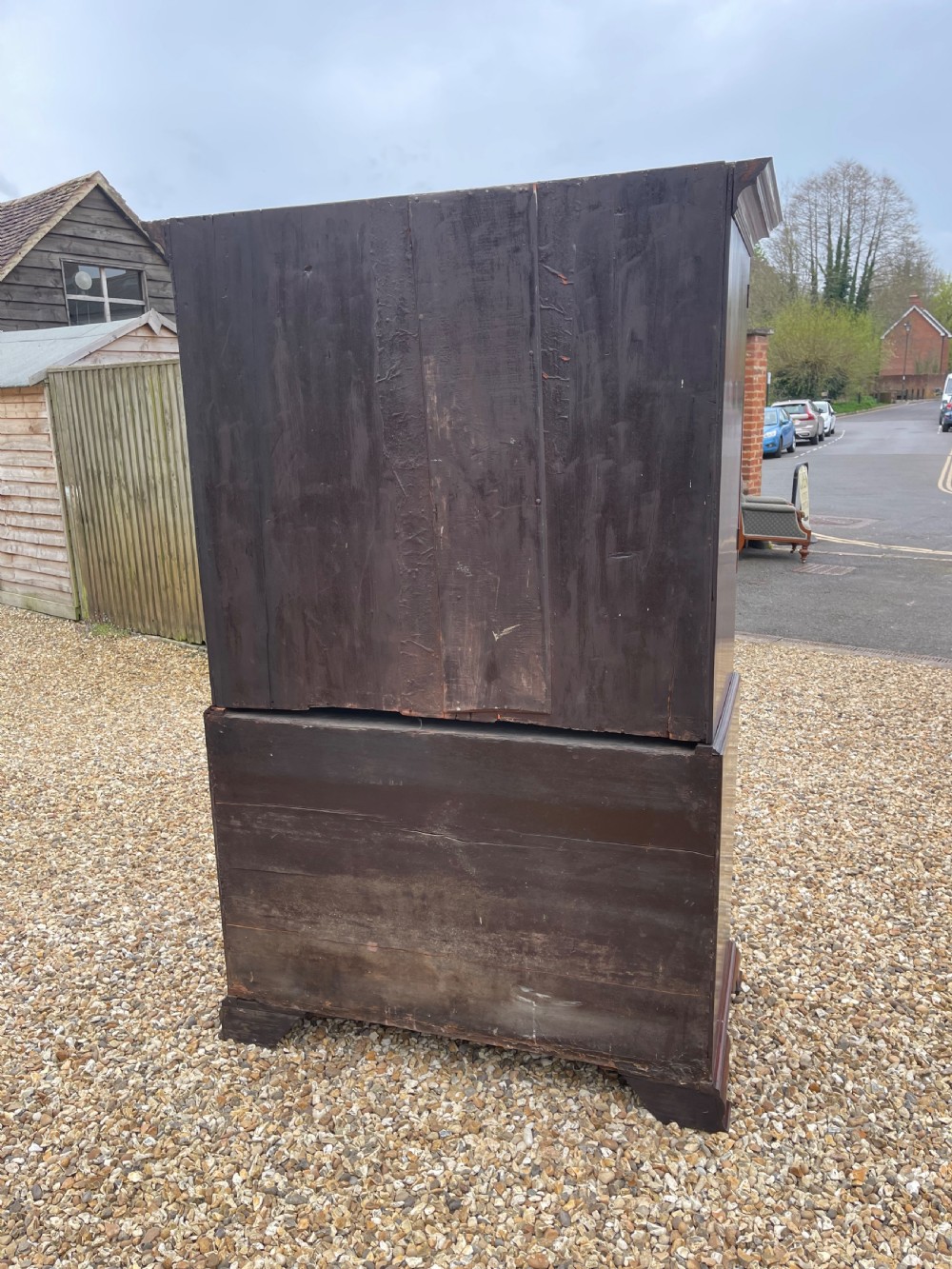 A tall Georgian mahogany secretaire press cupboard featuring two panelled doors above drawers with brass handles, resting on bracket feet. View XII
