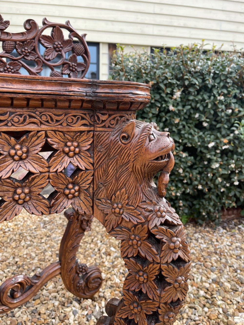 A nineteenth-century Anglo-Indian carved wood console table featuring a detailed openwork apron, gallery back, and intricately carved leg supports. View II