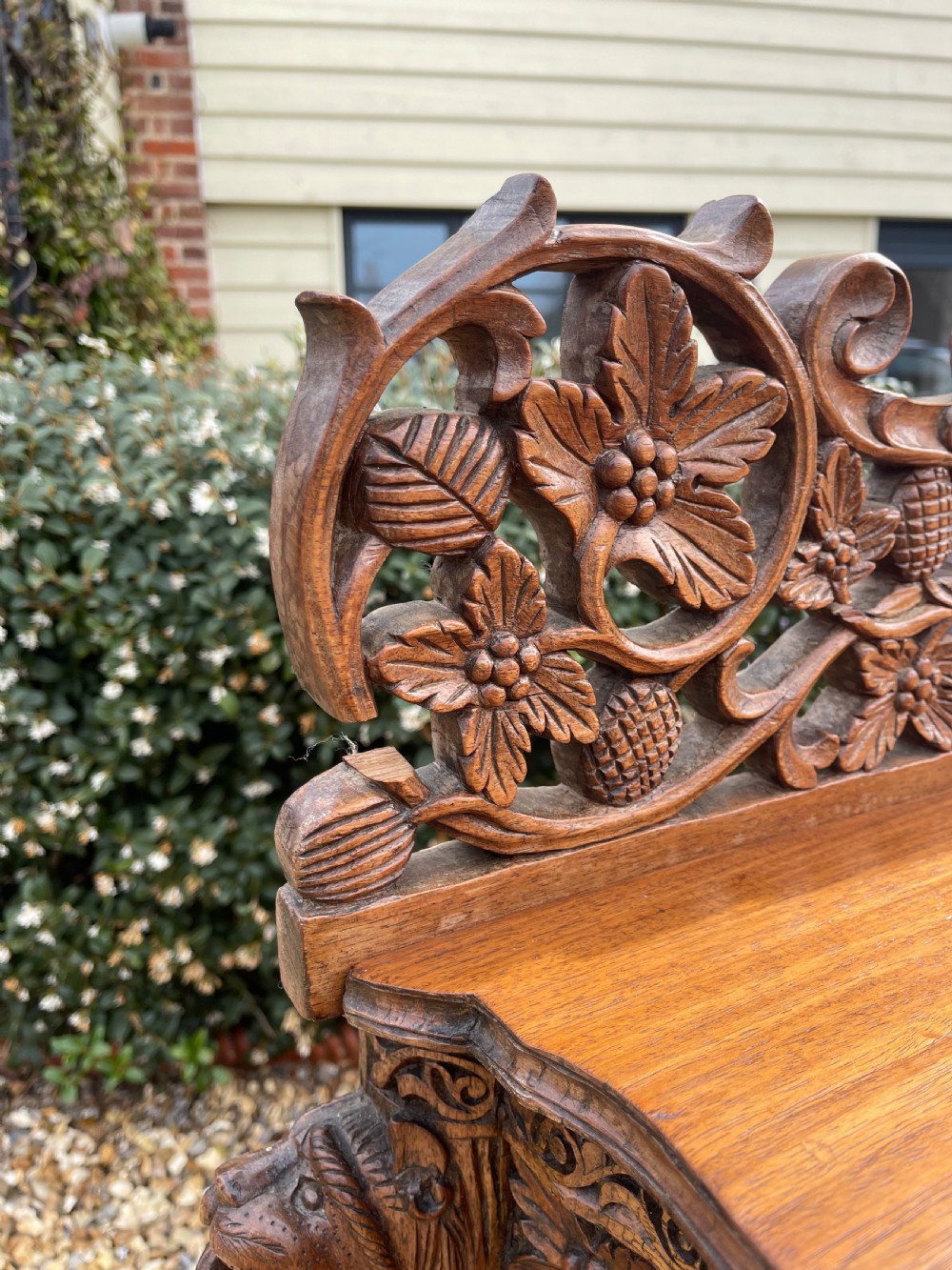 A nineteenth-century Anglo-Indian carved wood console table featuring a detailed openwork apron, gallery back, and intricately carved leg supports. View V