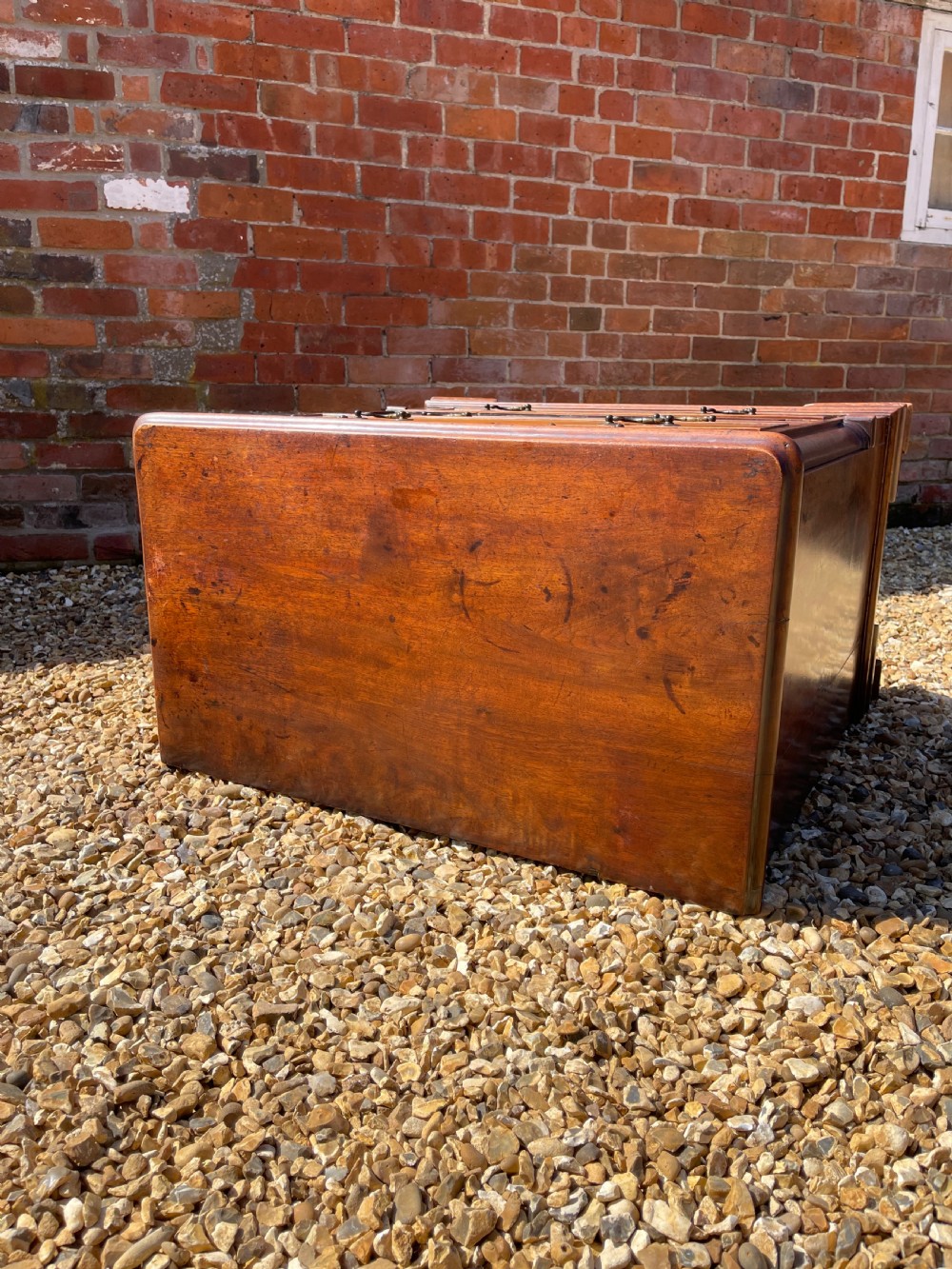 An eighteenth-century Georgian mahogany chest of drawers featuring two short drawers over three long drawers, finished with brass swan-neck handles and bracket feet. View V