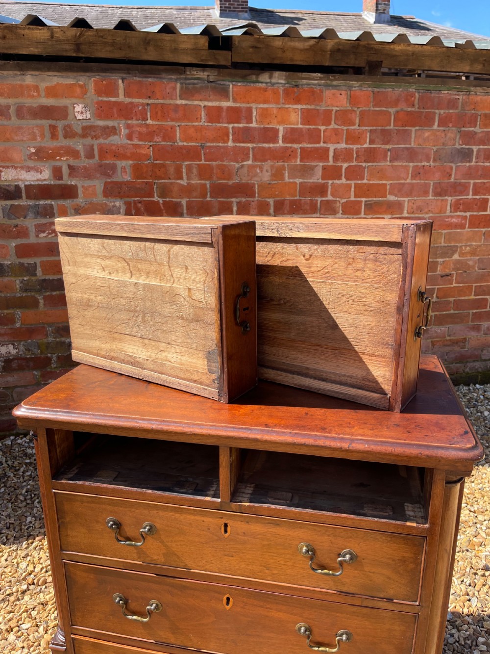 An eighteenth-century Georgian mahogany chest of drawers featuring two short drawers over three long drawers, finished with brass swan-neck handles and bracket feet. View VIII