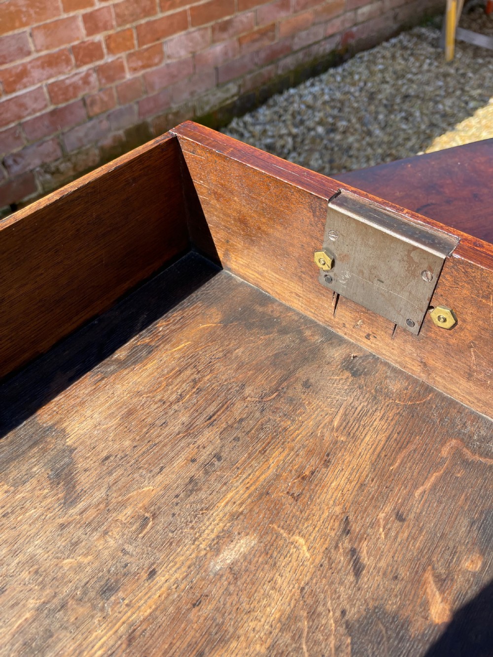 An eighteenth-century Georgian mahogany chest of drawers featuring two short drawers over three long drawers, finished with brass swan-neck handles and bracket feet. View IX