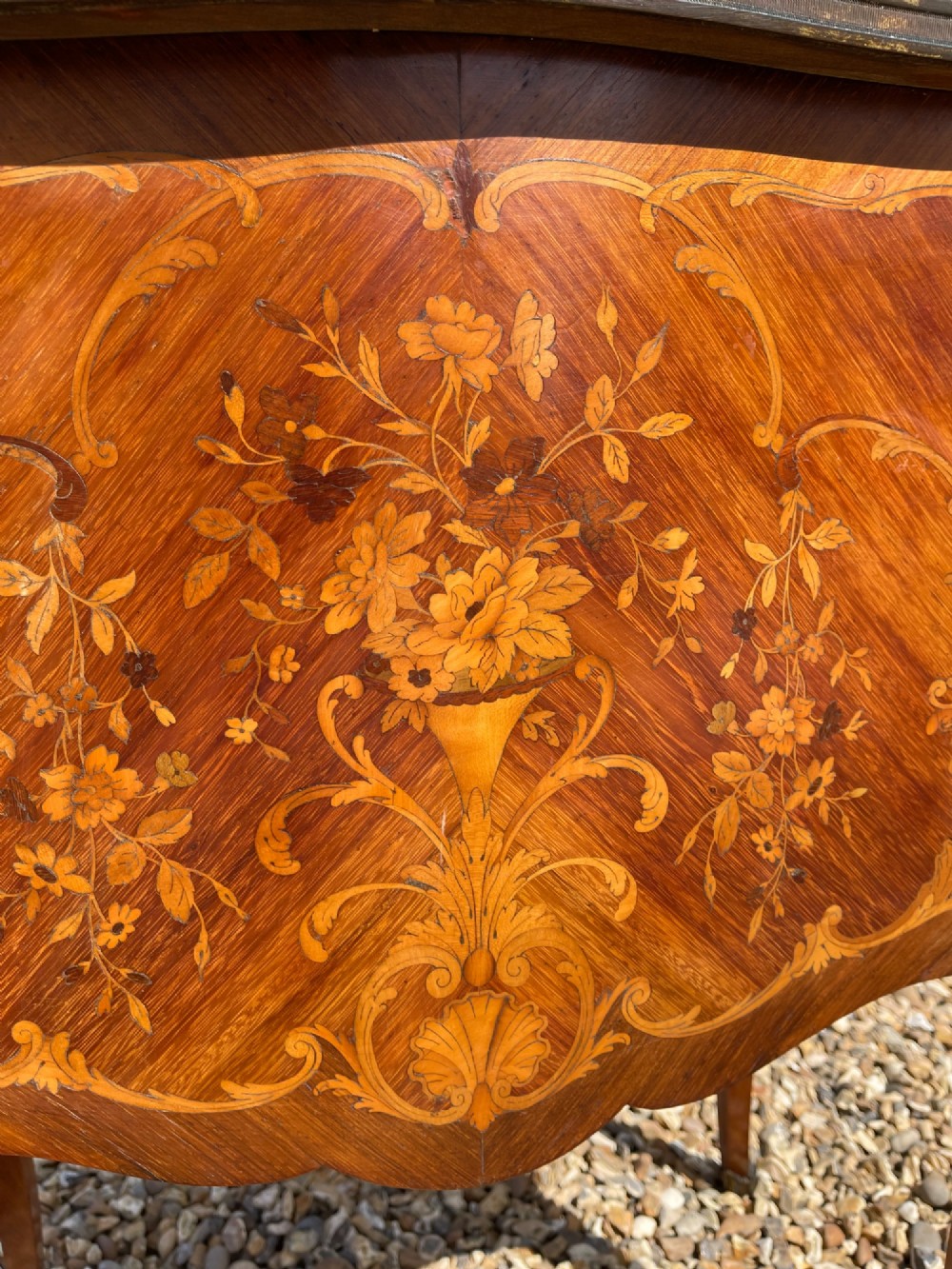 A late nineteenth-century French style side cabinet featuring floral marquetry wood inlay, a variegated marble top surrounded by a pierced brass gallery rim, cabriole legs, and a glazed door. View IV