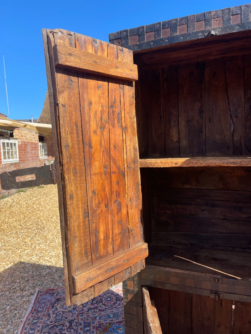 A tall nineteenth-century Indian wooden cupboard bound in dark iron lattice strapping with metal latches and double doors. View III