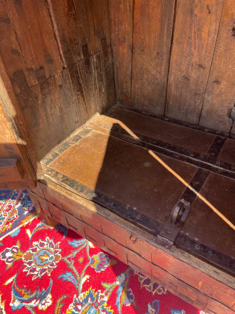 A tall nineteenth-century Indian wooden cupboard bound in dark iron lattice strapping with metal latches and double doors. View V