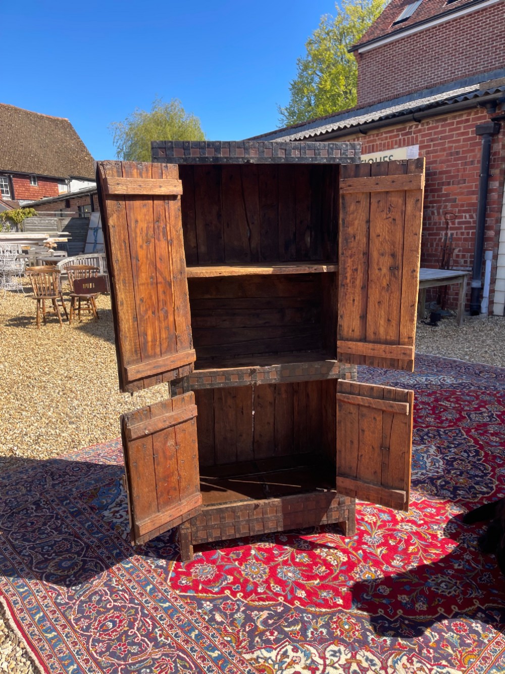 A tall nineteenth-century Indian wooden cupboard bound in dark iron lattice strapping with metal latches and double doors. View VI