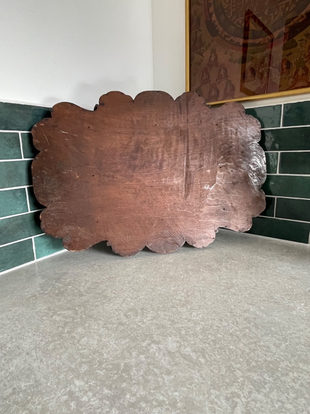 A dark brown carved walnut tray featuring a smooth central panel surrounded by a scalloped, intricately carved floral border. View IV