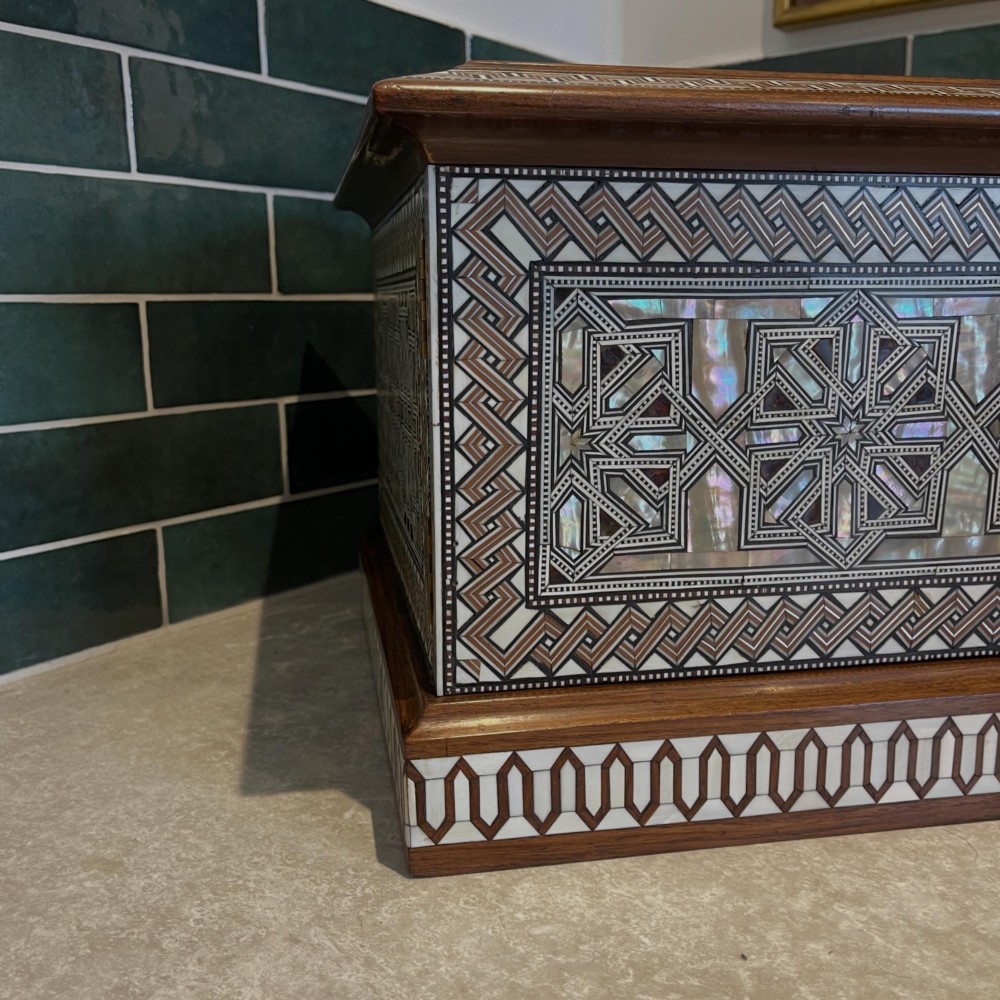 An Ottoman wooden tabletop cabinet featuring geometric mother-of-pearl and bone inlay, with a open side door revealing internal drawers. View II