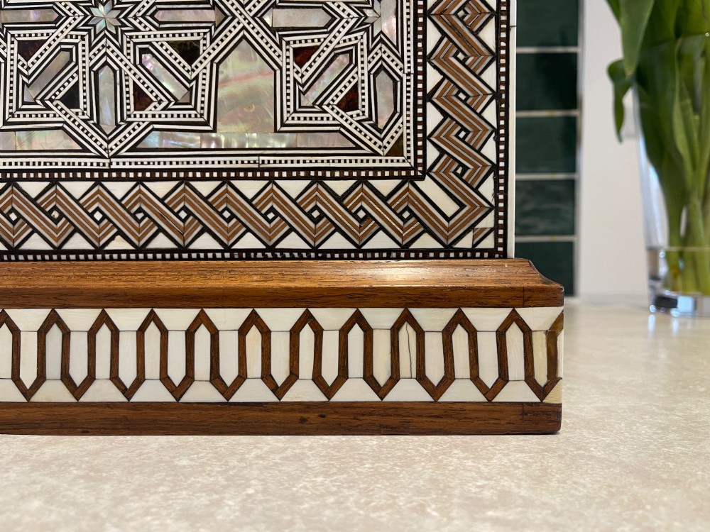 An Ottoman wooden tabletop cabinet featuring geometric mother-of-pearl and bone inlay, with a open side door revealing internal drawers. View V