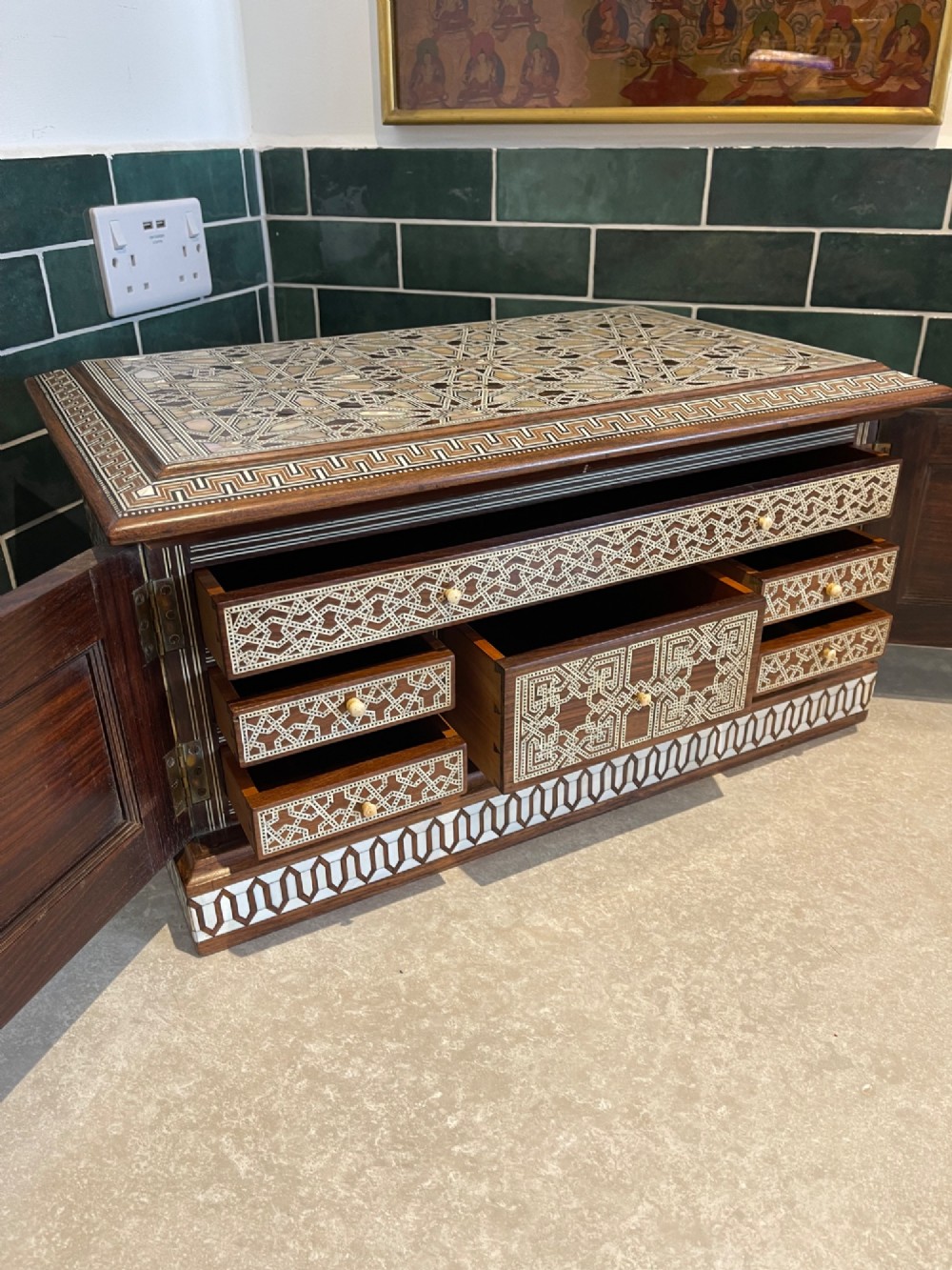 An Ottoman wooden tabletop cabinet featuring geometric mother-of-pearl and bone inlay, with a open side door revealing internal drawers. View X