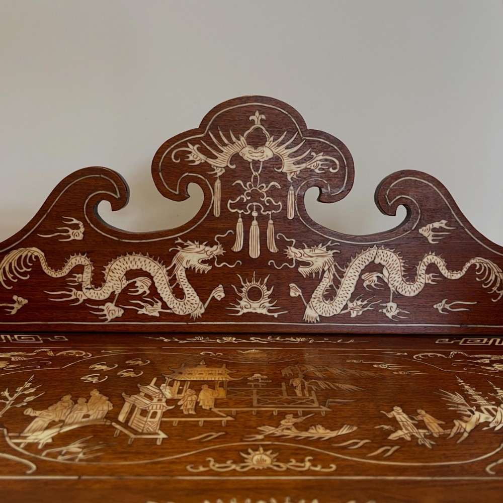 A dark wood Chinese table cabinet featuring two doors embellished with detailed mother-of-pearl landscape inlays, flanked by decorative borders and topped with a carved cresting. View III