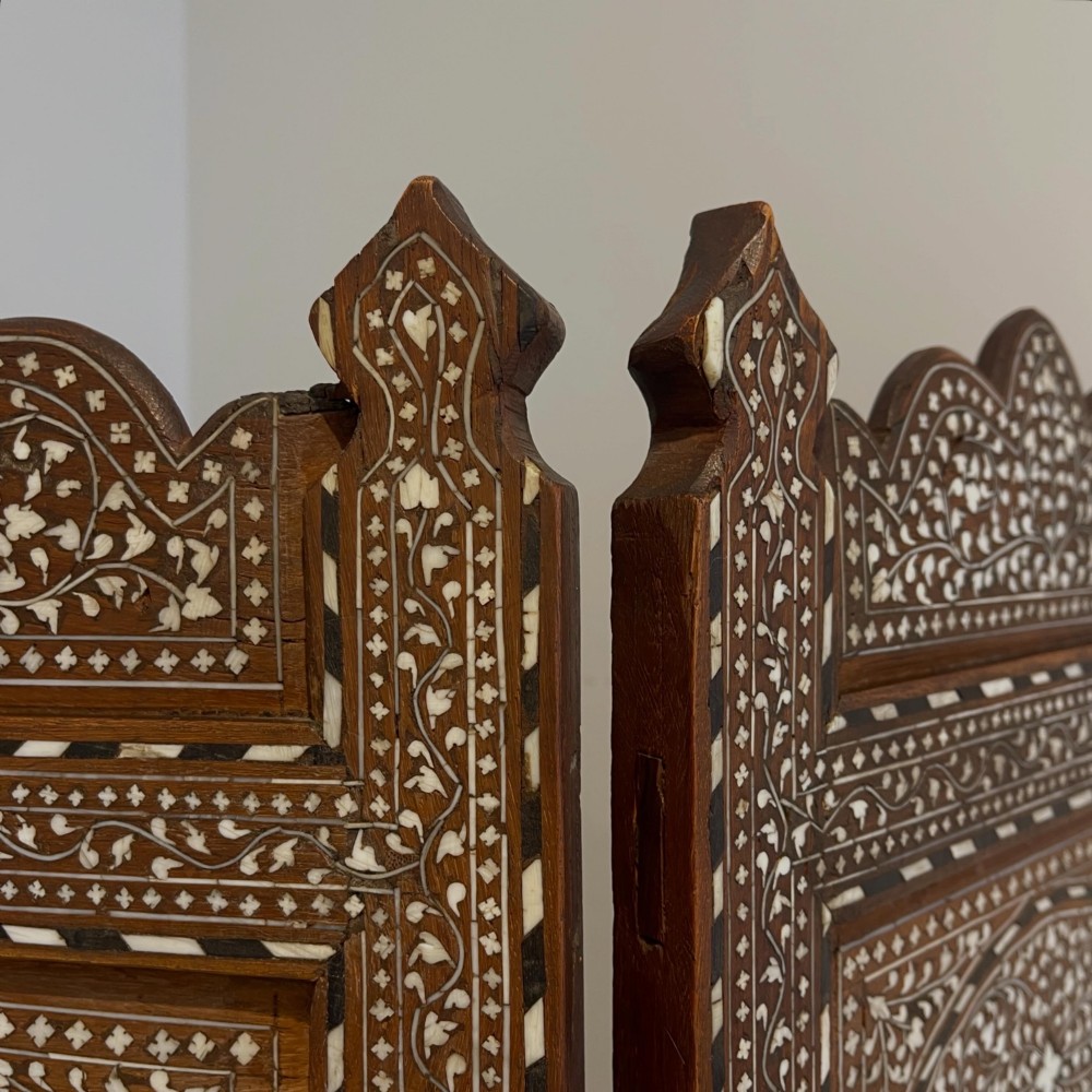 A three-panel Anglo-Indian folding table screen crafted from dark wood with white floral bone inlay patterns. View III