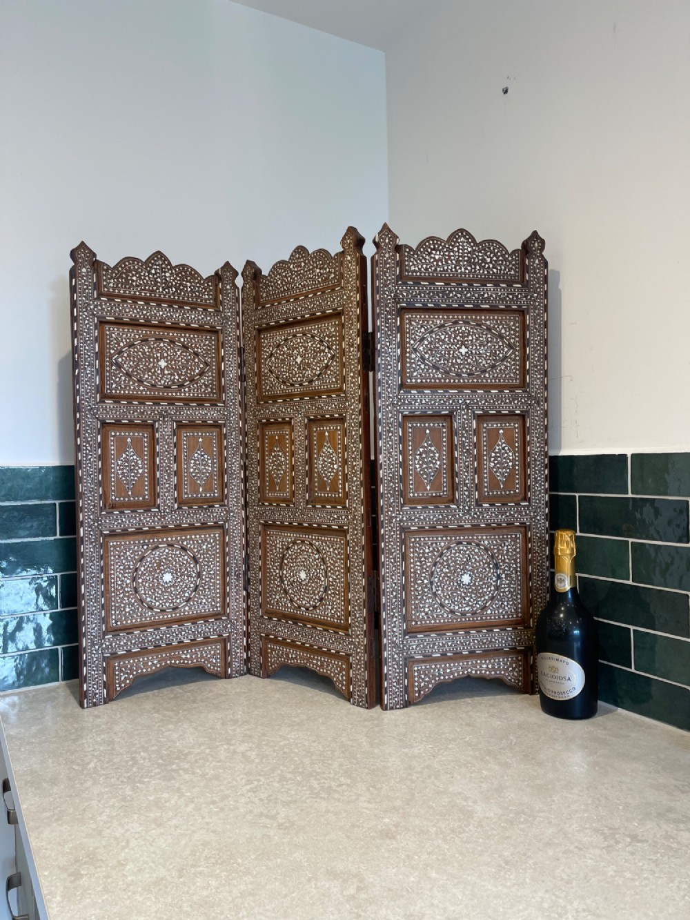 A three-panel Anglo-Indian folding table screen crafted from dark wood with white floral bone inlay patterns. View VII