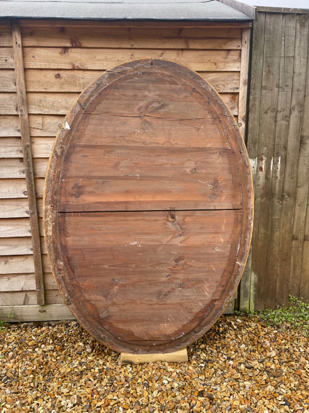 A large oval wall mirror featuring a gilded wood and gesso frame with beaded and moulded decorative borders. View III