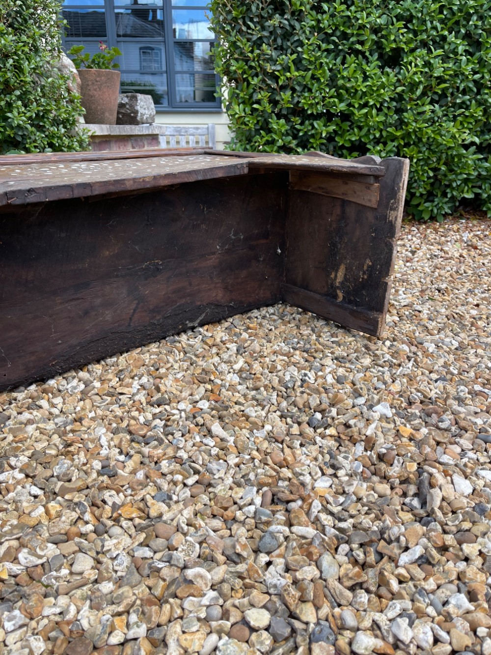 A dark walnut Syrian storage trunk decorated with detailed white mother-of-pearl floral and geometric inlay across the front panel and raised trestle base. View IV