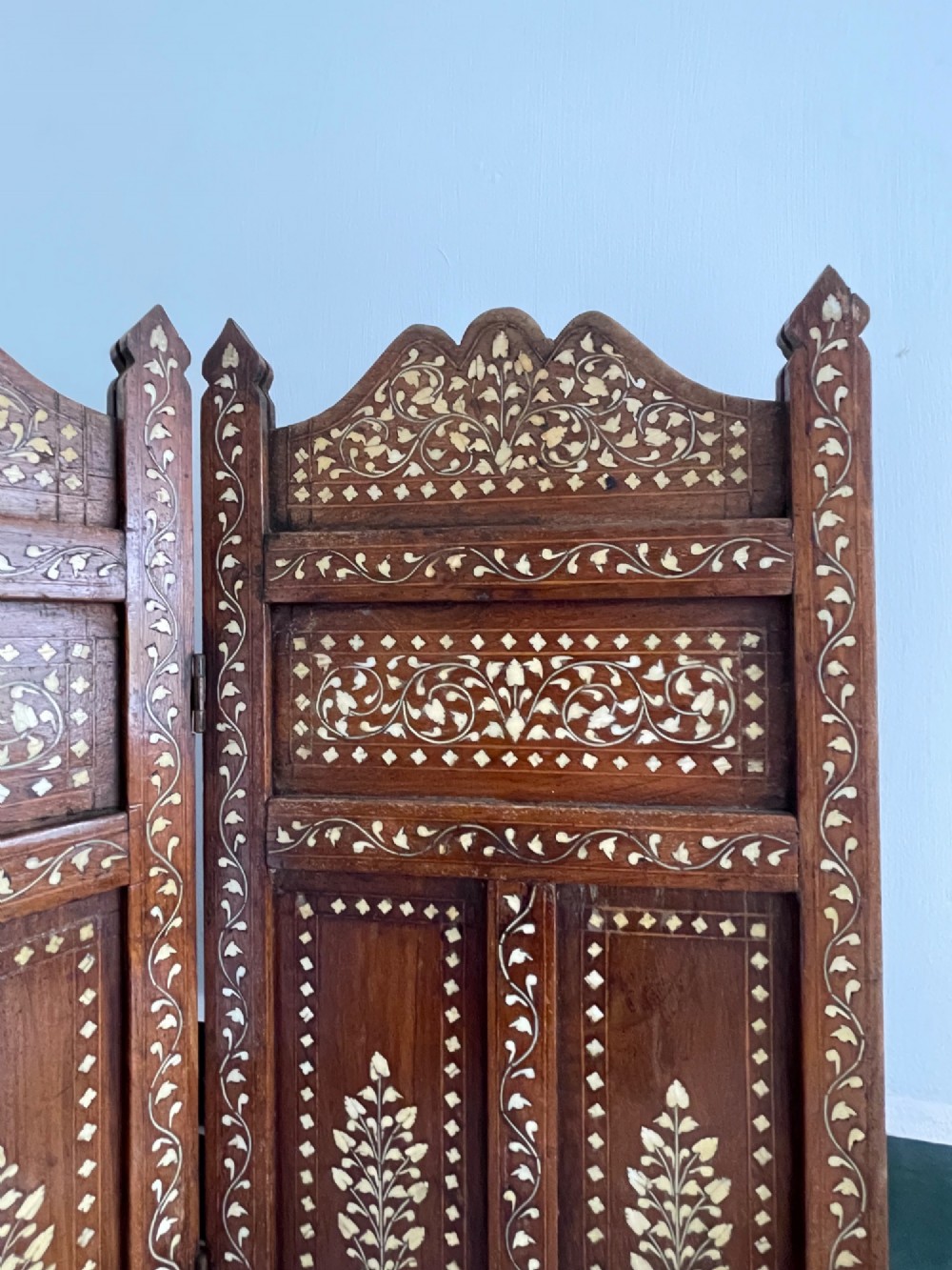 A four-panel Anglo-Indian miniature folding table screen constructed from dark brown wood with dense floral bone inlay decoration. View III
