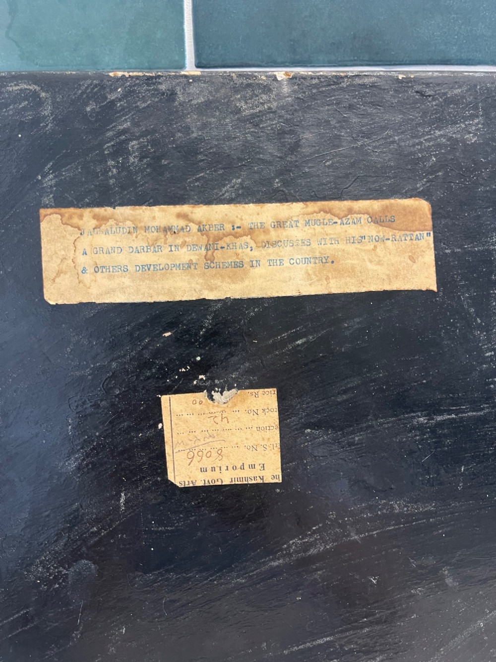 An octagonal Kashmiri papier-mache tray featuring a detailed hand-painted court scene with figures surrounded by a calligraphic border. View IV