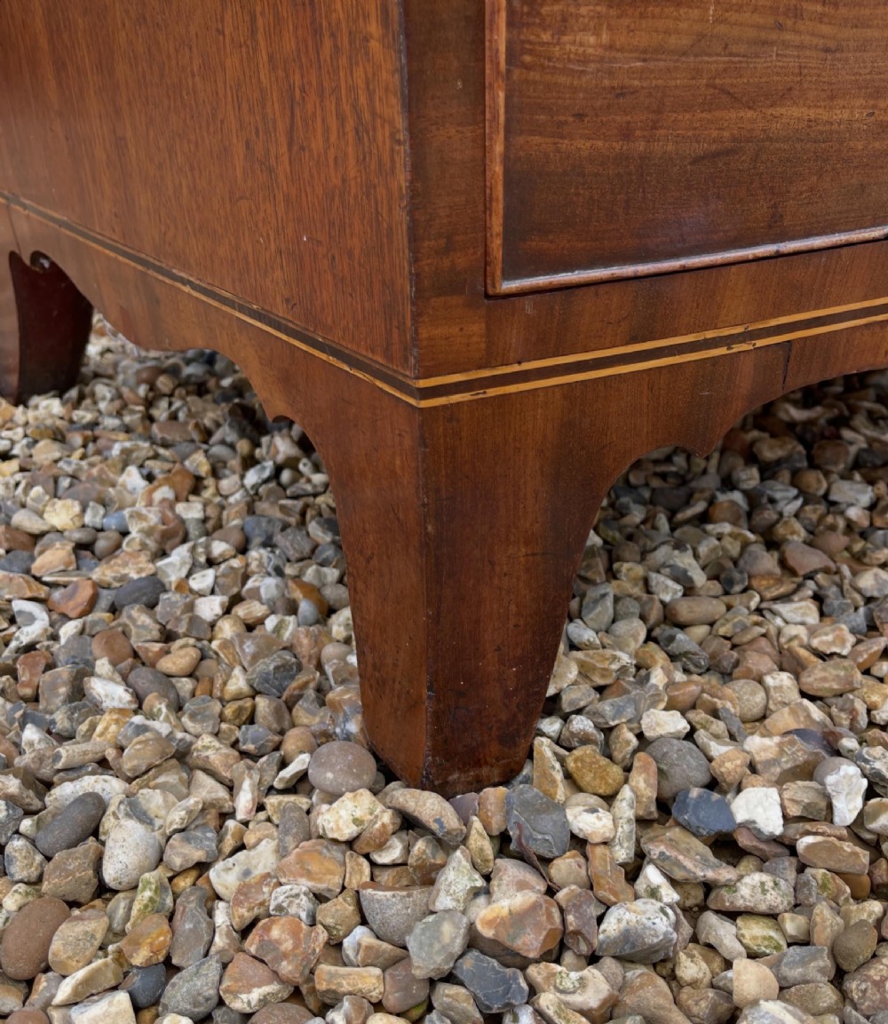 A Georgian mahogany bowfronted chest of drawers featuring two short over three long drawers with turned wooden knobs and splayed bracket feet. View III