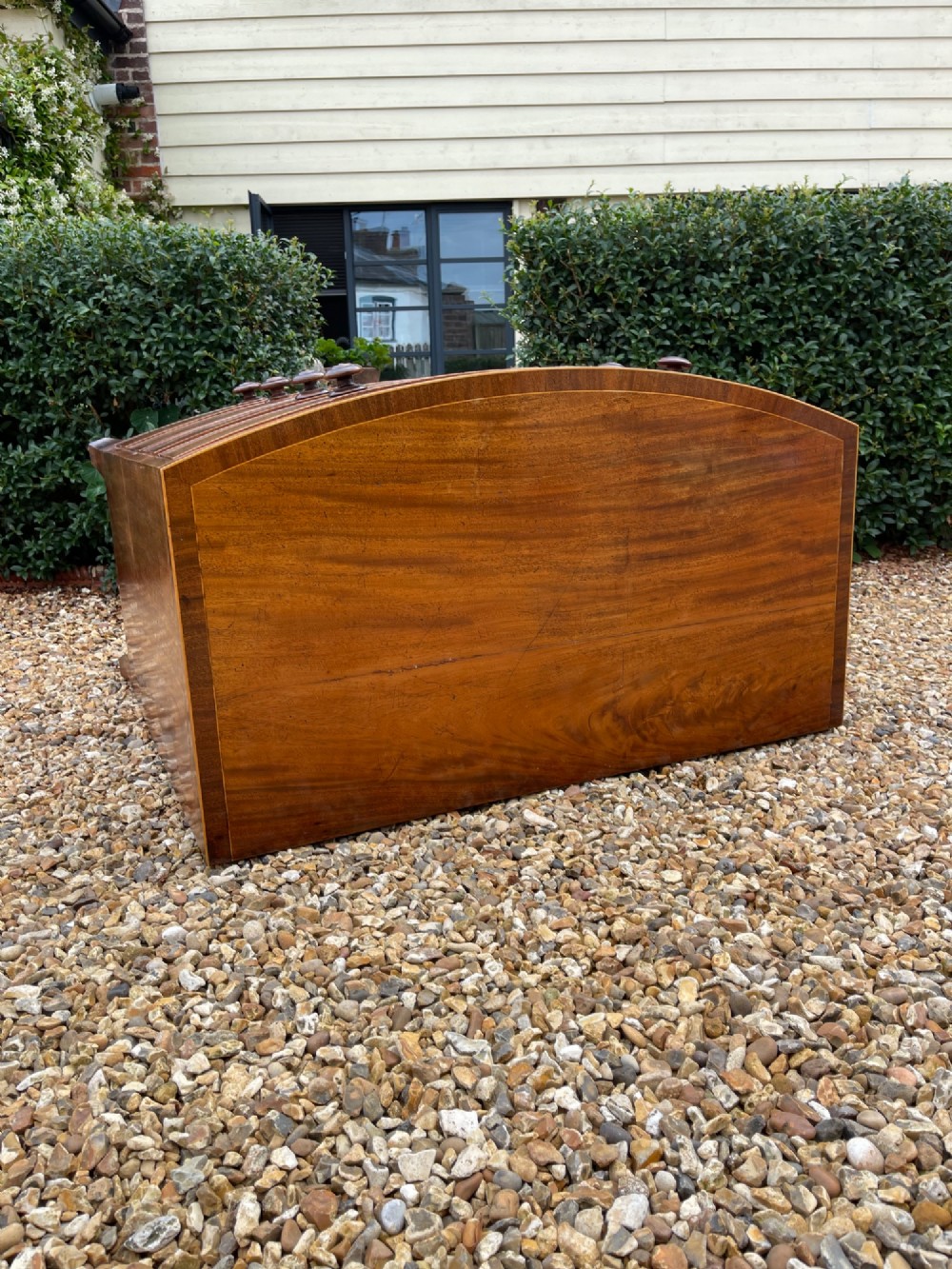 A Georgian mahogany bowfronted chest of drawers featuring two short over three long drawers with turned wooden knobs and splayed bracket feet. View VI