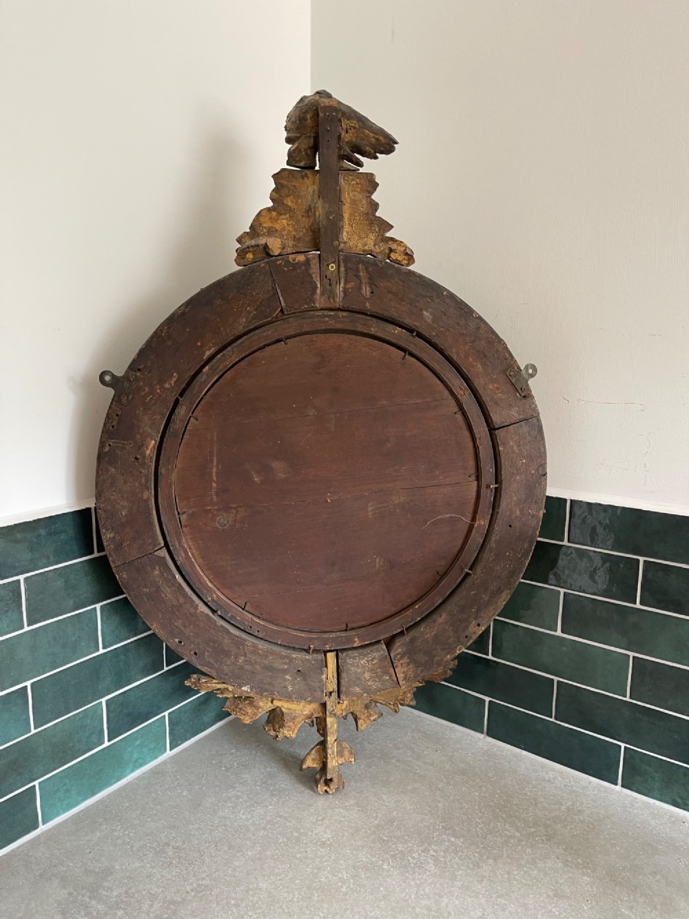 A circular Georgian giltwood convex wall mirror topped with a carved eagle cresting and featuring a frame decorated with ball spherules and an acanthus leaf apron. View IV