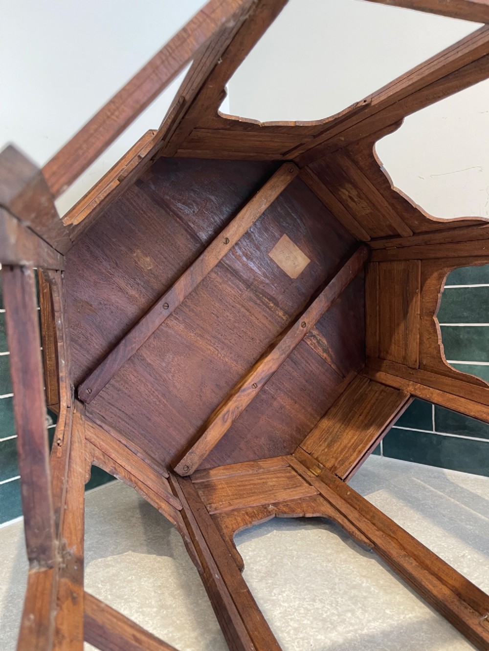 An octagonal Anglo-Indian dark wood side table decorated with dense bone inlay featuring floral patterns, geometric borders, and arched legs. View IV