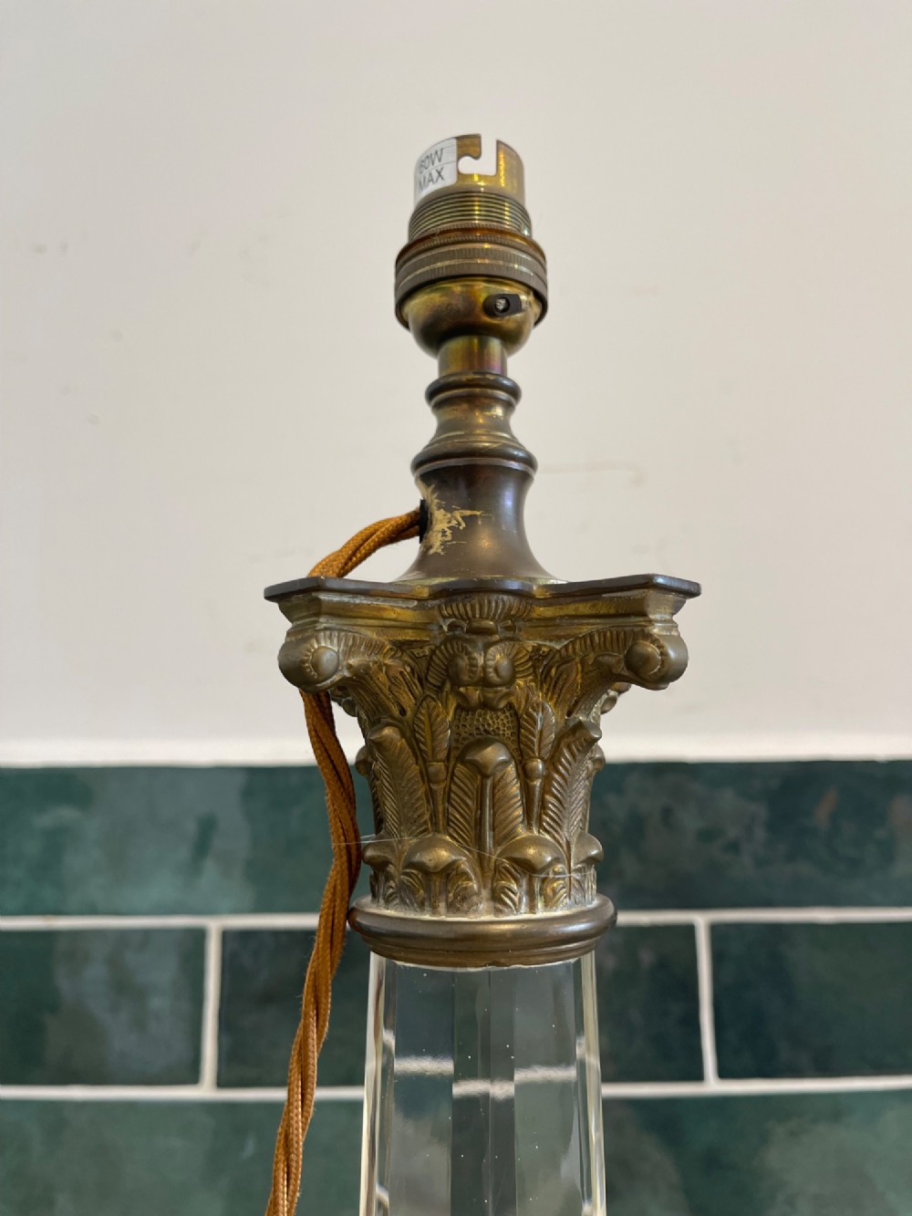 A 19th-century clear cut glass table lamp featuring a brass Corinthian capital mount and a stepped square base. View II