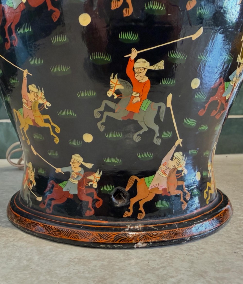A hand-painted black papier-mache table lamp base depicting figures on horseback playing polo. View II