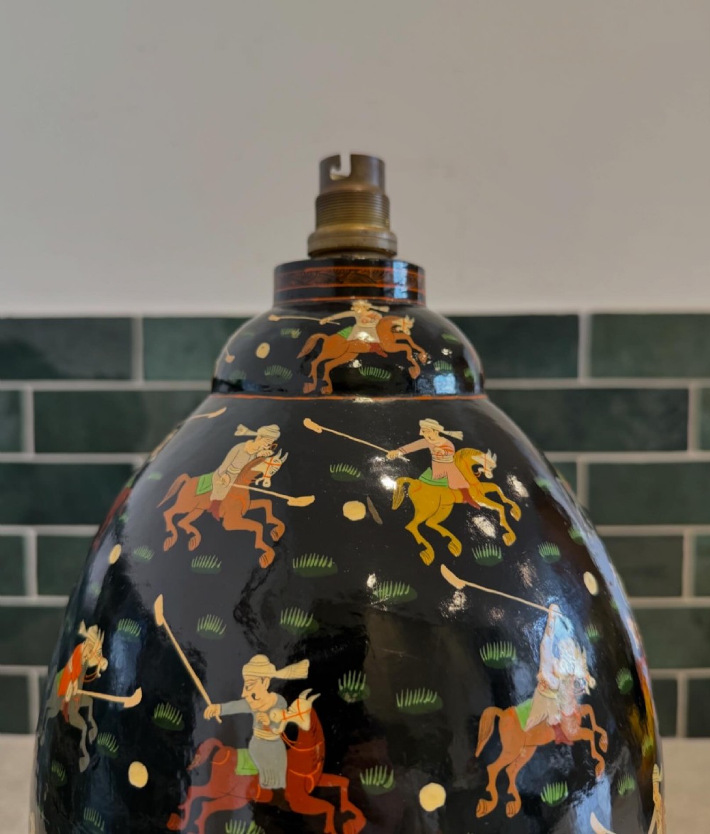 A hand-painted black papier-mache table lamp base depicting figures on horseback playing polo. View III