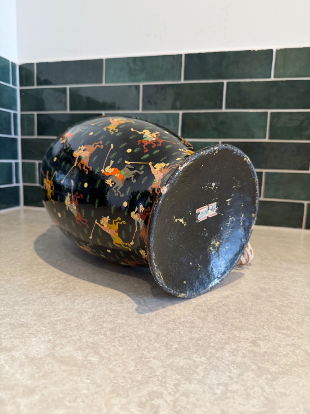 A hand-painted black papier-mache table lamp base depicting figures on horseback playing polo. View IV