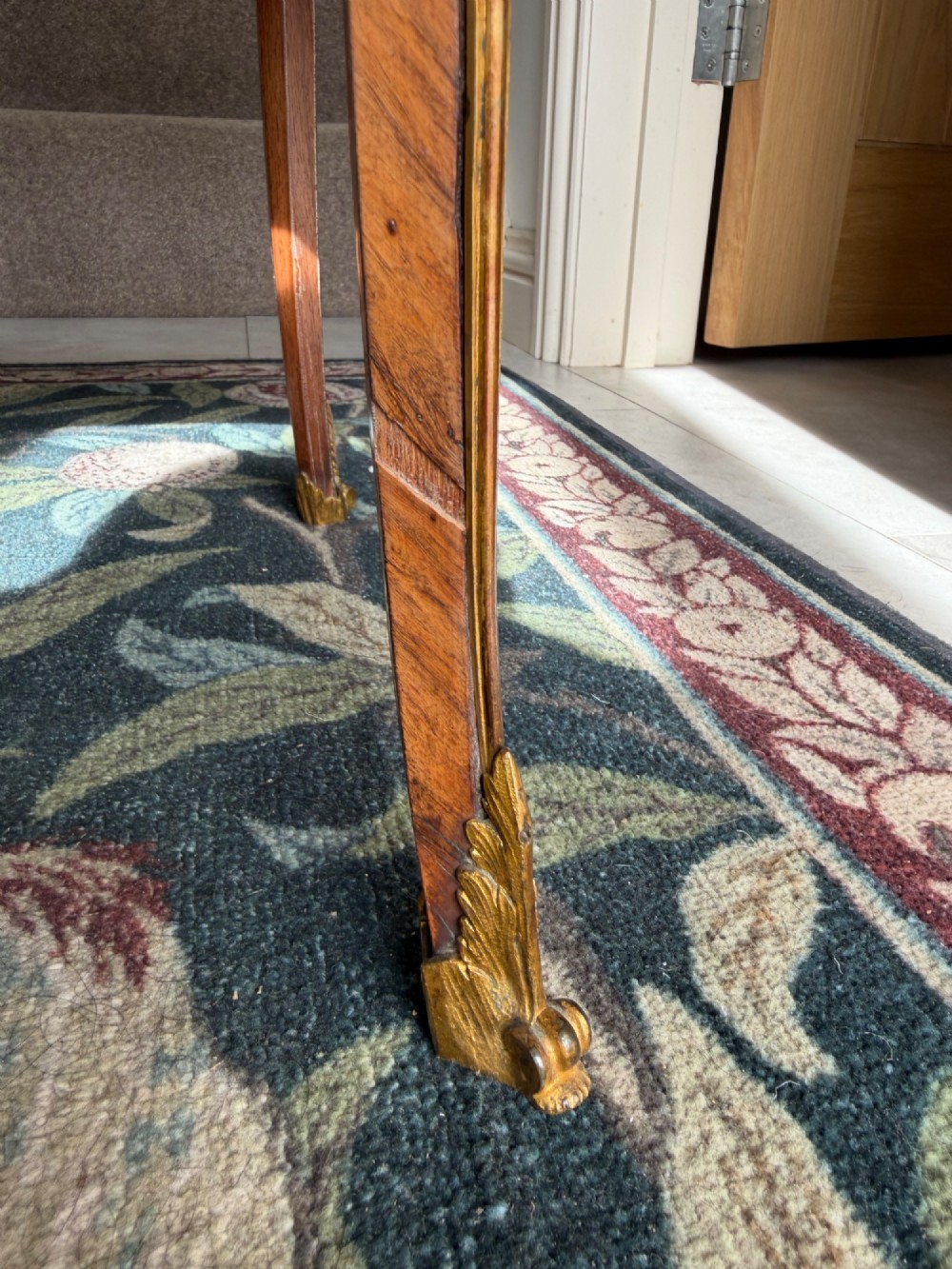 An oval French Louis XV style kingwood side table featuring a mottled red marble top, pierced brass gallery, floral marquetry inlay, and cabriole legs with bronze mounts. View II