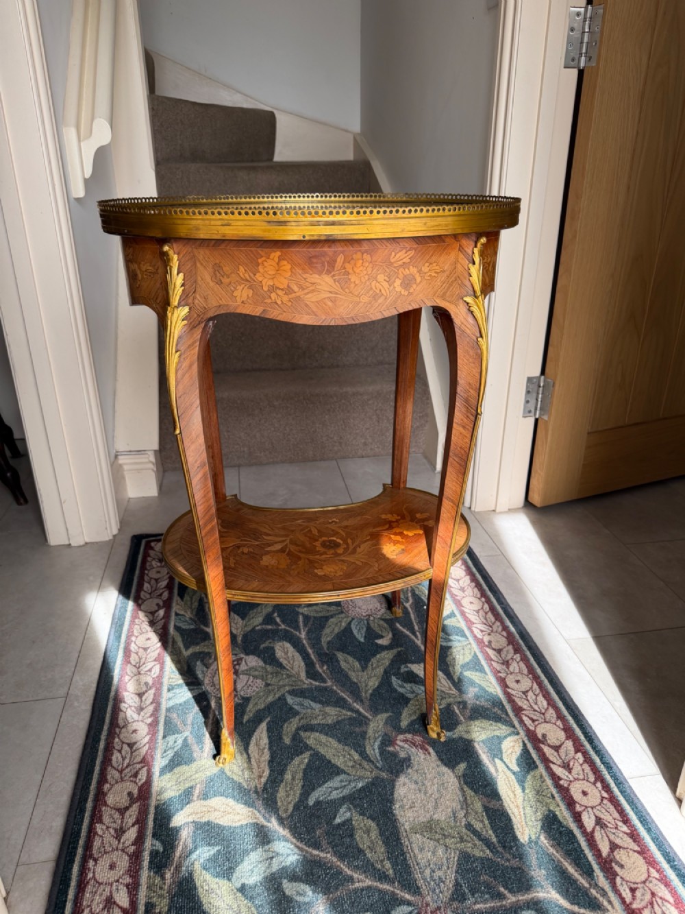 An oval French Louis XV style kingwood side table featuring a mottled red marble top, pierced brass gallery, floral marquetry inlay, and cabriole legs with bronze mounts. View IV